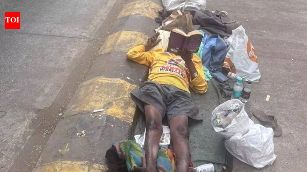 A beggar was spotted reading Sidney Sheldon while lying on the footpath in a viral post: Who is he? |