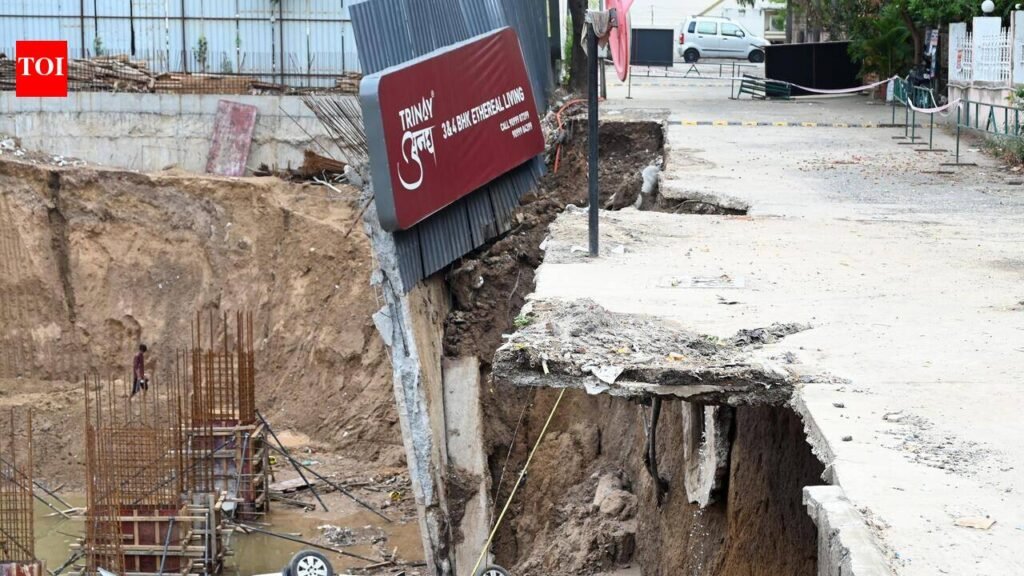 Car plunges into pit as compound wall collapses at construction site in Ahmedabad’s Satellite area | Ahmedabad News