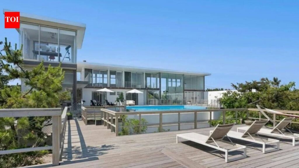A Fire Island glass house drew 350+ viewers at $5.25 million but no buyer; after $1.255 million in cuts, its $3.995 million ask is still nearly $1.3 million above Cherry Grove’s record sale